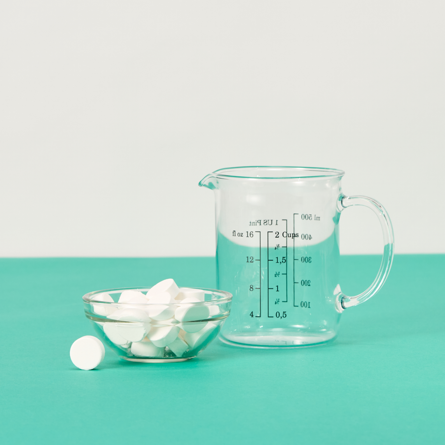 EcoBrite Tables in a bowl next to a measuring cup